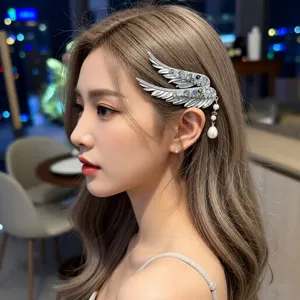 Elegant detail showing a crystal angel wing hair clip with pearl tassel on a model