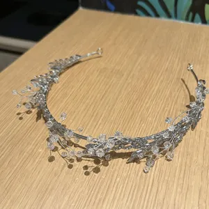 Intricate detail of silver-tone bridal headpiece adorned with clear sparkling crystals