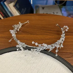 Detailed view of elegant bridal hair chain with crystals and silver leaf design.