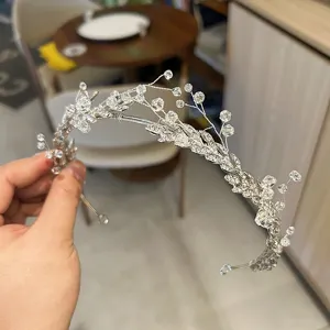 Elegant bridal crystal tiara with detailed leaf and vine patterns in silver finish