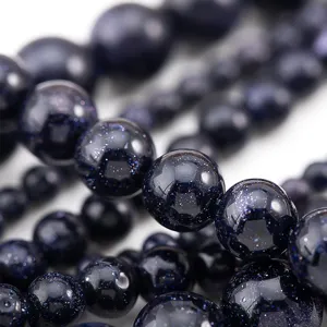 Macro shot of dreamy starry sky blue glass beads with glittering effect for DIY jewelry