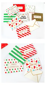 Close-up of mini Christmas cards with festive patterns and matching cream envelopes