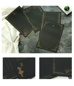 Detail view of vintage black A5 stationery with gold foil patterns and texture