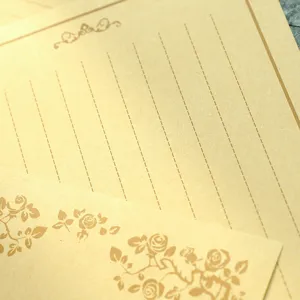 Macro view of vintage kraft stationery paper with delicate floral patterns and dotted lines