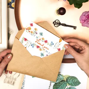Elegant bohemian wildflower thank you card with a brown kraft envelope for weddings
