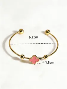 Stainless steel open cuff bracelet featuring a charming pink four-leaf clover and gold balls.