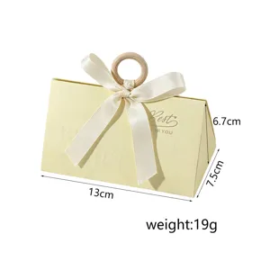 Elegant cream triangle wedding candy box with ribbon and wooden ring handle details