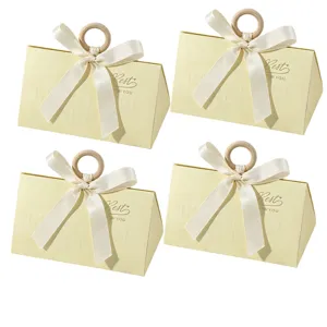 Elegant set of 4 cream triangular wedding favor boxes with ribbon and wood ring.