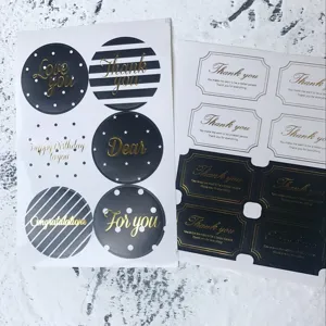 Detailed view of gold foil thank you stickers used for gift packaging and sealing
