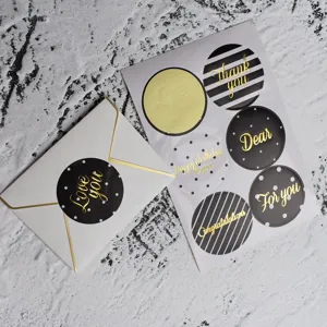 Macro detail of gold foil greeting stickers with various thank you and birthday messages