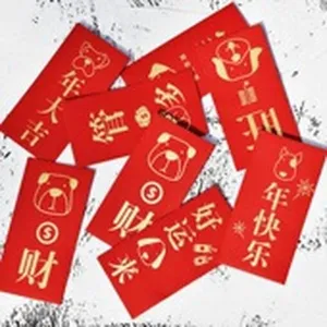 Detail of red envelopes with gold embossed Chinese New Year blessings and dog graphics