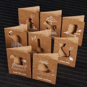Macro view of kraft paper greeting cards with intricate laser-cut animal designs