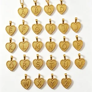 Gold heart alphabet pendant detail, stainless steel custom initial necklace charm accessory.