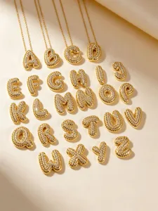 Close up detail of 26 alphabet bubble letter pendants sparkling with pave rhinestones.