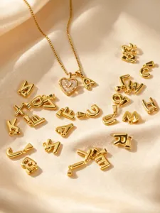 Gold stainless steel necklace with mother of pearl heart pendant and initial letters charm.
