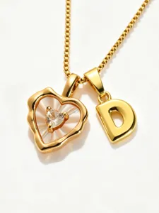 Gold stainless steel box chain necklace with mother of pearl heart and letter D pendant.
