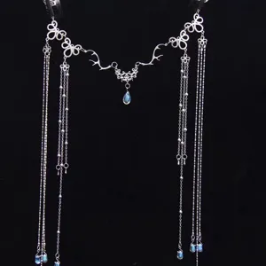 Detailed view of silver bridal hair chain with crystal waterdrop tassels and filigree