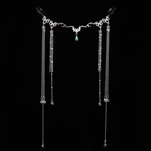 Macro detail of elegant bridal silver headpiece with delicate crystal teardrop chain
