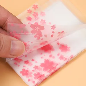 Frosted translucent self-adhesive packaging bags featuring pink cherry blossom prints