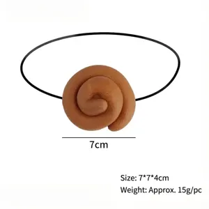 Detailed view of realistic brown spiral poop prank toy prop with 7cm size marker