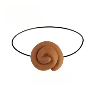 Detailed view of simulated poop prank prop with elastic band for Halloween tricks