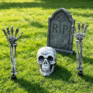Detailed view of realistic skull and skeleton hand lawn stakes for Halloween garden decor