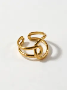 Close-up of modern geometric hollow gold ring detail, stylish stainless steel fashion design.