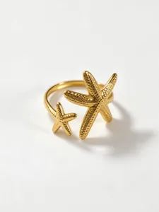 Detailed view of the trendy gold stainless steel double starfish open ring with fine texture.