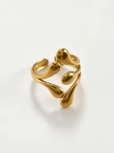 Close-up detail of geometric hollow open ring, 18K gold stainless steel fashion jewelry.