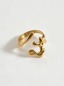 Detailed close-up of the modern geometric hollow stainless steel gold ring showcasing fine texture.