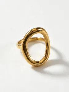Detail shot of modern geometric hollow gold ring, abstract curved design and polished finish.