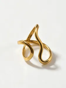 Gold stainless steel geometric abstract hollow statement ring modern stylish jewelry design detail.