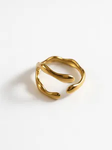 Minimalist gold geometric hollow ring detail view, modern stainless steel open design.