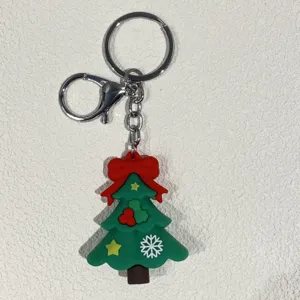 Detailansicht eines grünen Tannenbaum-Schlüsselanhängers mit roter Schleife und Ring.