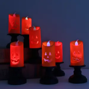 Halloween pumpkin LED electronic candles with black holders for spooky indoor decor