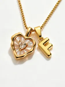 Gold stainless steel box chain necklace featuring mother of pearl heart and letter F pendant.