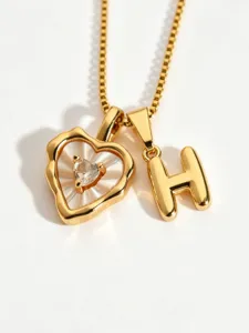 Stainless steel box chain necklace featuring an irregular mother-of-pearl heart and letter H pendant.