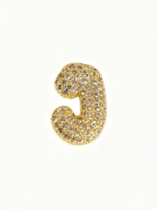 Closeup of the gold-plated bubble letter pendant showcasing sparkling pavé diamond details.