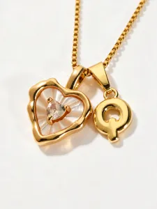 Gold stainless steel box chain necklace with mother of pearl heart and letter Q pendant.