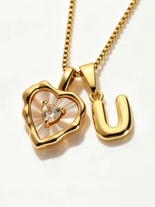 Gold stainless steel mother of pearl heart and letter U pendant necklace jewelry detail view.