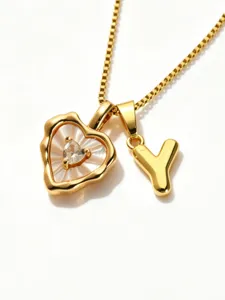 Gold box chain necklace featuring mother-of-pearl heart pendant and letter Y charm.
