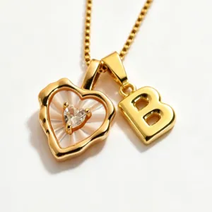 Gold stainless steel box chain necklace featuring mother of pearl heart and initial B pendants.
