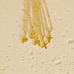 Minimalist gold stainless steel bubble letter pendant necklace delicate jewelry for women.