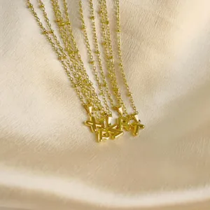 Gold dainty bubble letter pendant necklaces with delicate bead chains for women stylish jewelry.