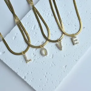 Gold stainless steel herringbone chain necklace with sparkling crystal letter pendants love design.