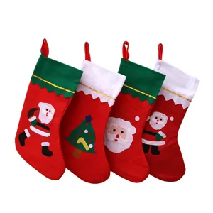 Set of four red felt Christmas stockings with Santa and tree appliqués for holiday decor