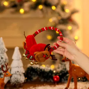 Detail view of festive plush Christmas earmuffs featuring a cute cartoon reindeer design.