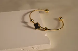 Exquisite gold-plated stainless steel cuff bracelet featuring a black clover motif and beads.