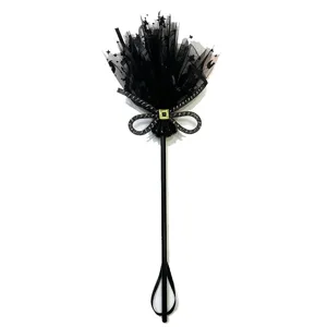 Detailed view of Halloween witch broom prop with black tulle stars and moon decoration