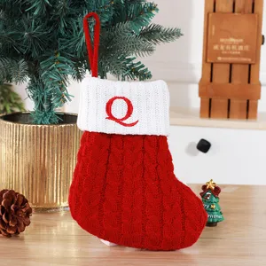 Red knitted Christmas stocking with white cuff and red embroidered letter Q decoration